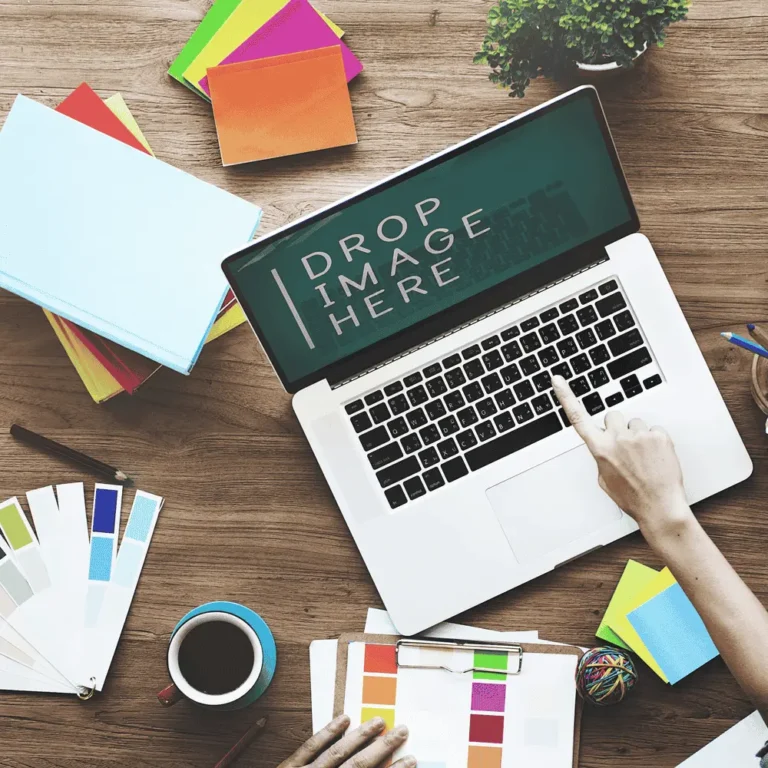 Creative workspace setup showcasing web design planning for small businesses. Includes a laptop, color palette, coffee, and brainstorming materials.