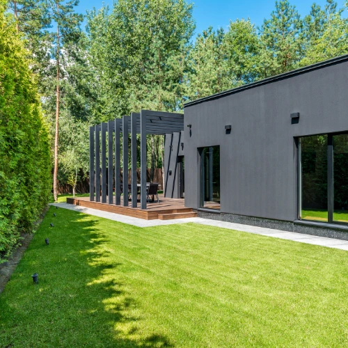 Modern house with sleek architecture, surrounded by greenery—small businesses in home design can benefit from budget-friendly web solutions.